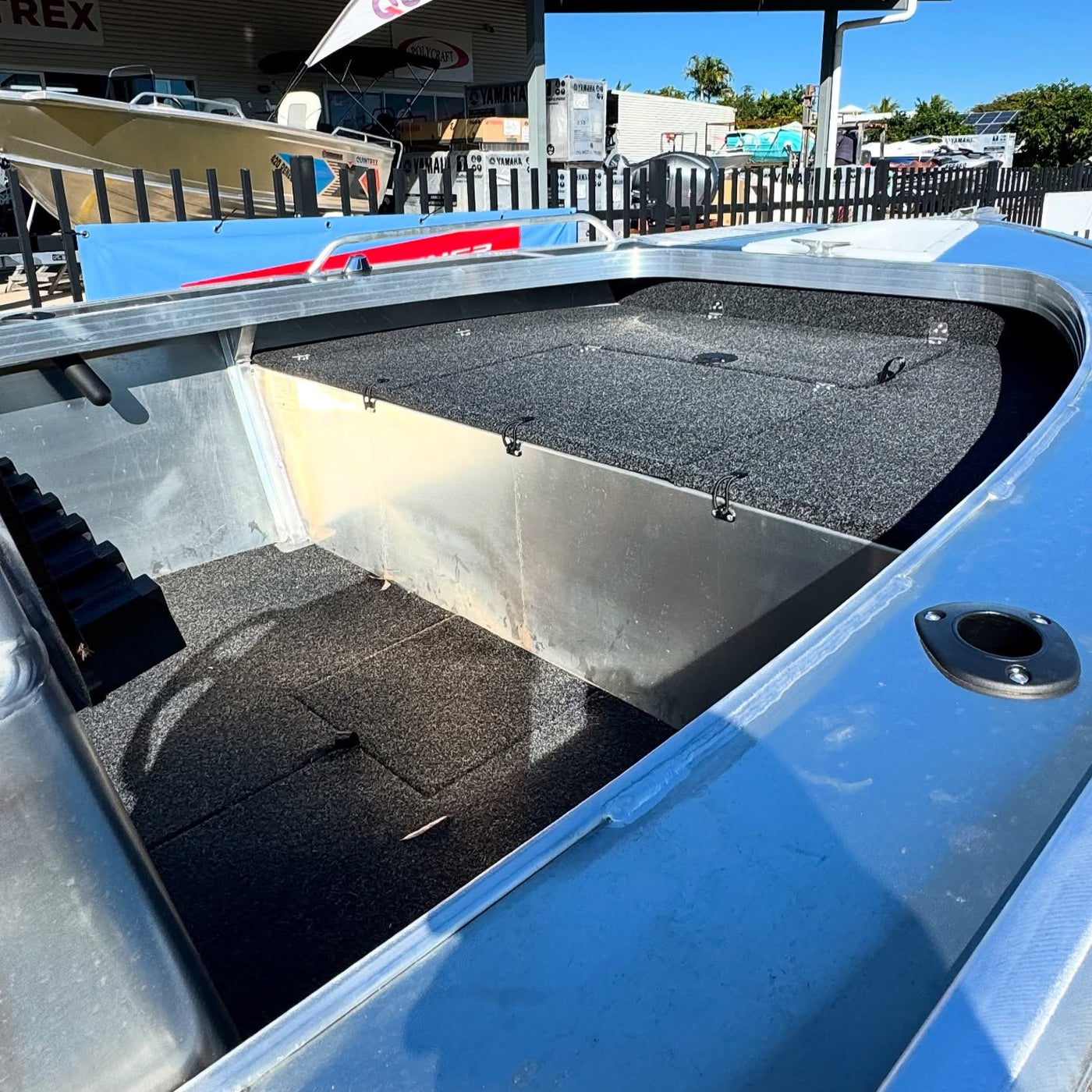 Blue boat interior with a Quintrex sign in the background
